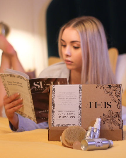 SE-LF In-Room Experience Gift Sets | A woman lays on a bed reading the magazine from one of the gift sets