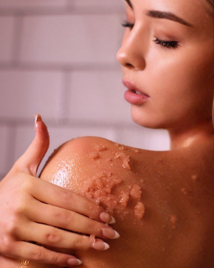 Professional Body Exfoliation Treatments by SE-LF | A woman applies salt scrub to her shoulder