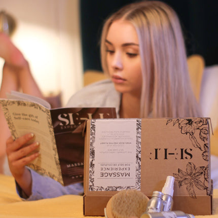 SE-LF In-Room Experience Gift Sets | A woman lays on a bed reading the magazine from one of the gift sets