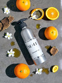 SE-LF Luxury Amenities | A woman reads the label of a body wash in reusable packaging
